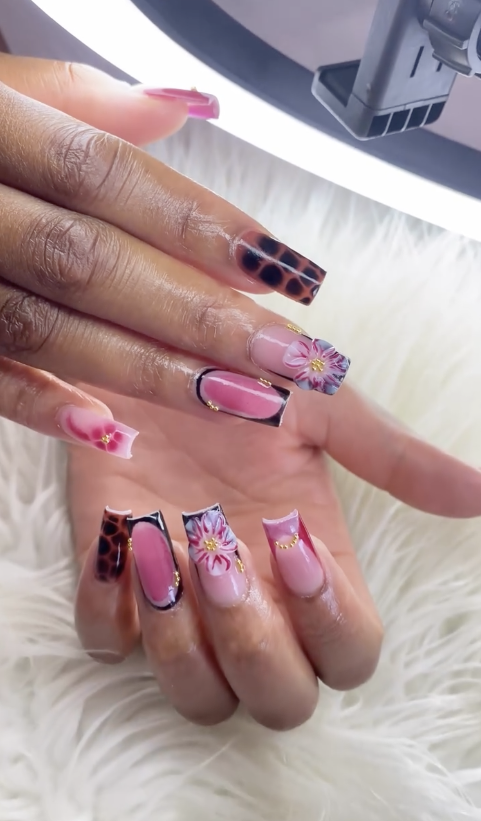Bold black leopard print and pink floral nail art